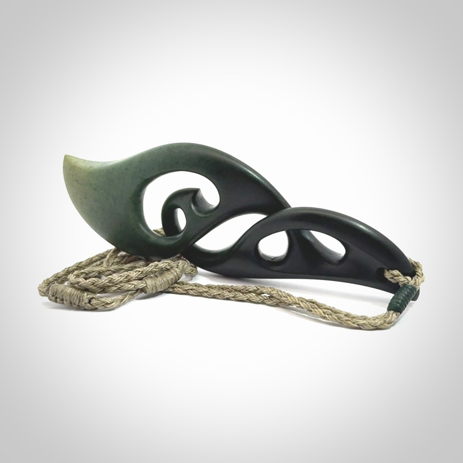 Hand carved New Zealand jade, complex twist drop pendant. Hand made complex twist pendant hand carved in New Zealand. Made by NZ Pacific, jade jewellery for sale online. One only hand made by Kerry Thompson.