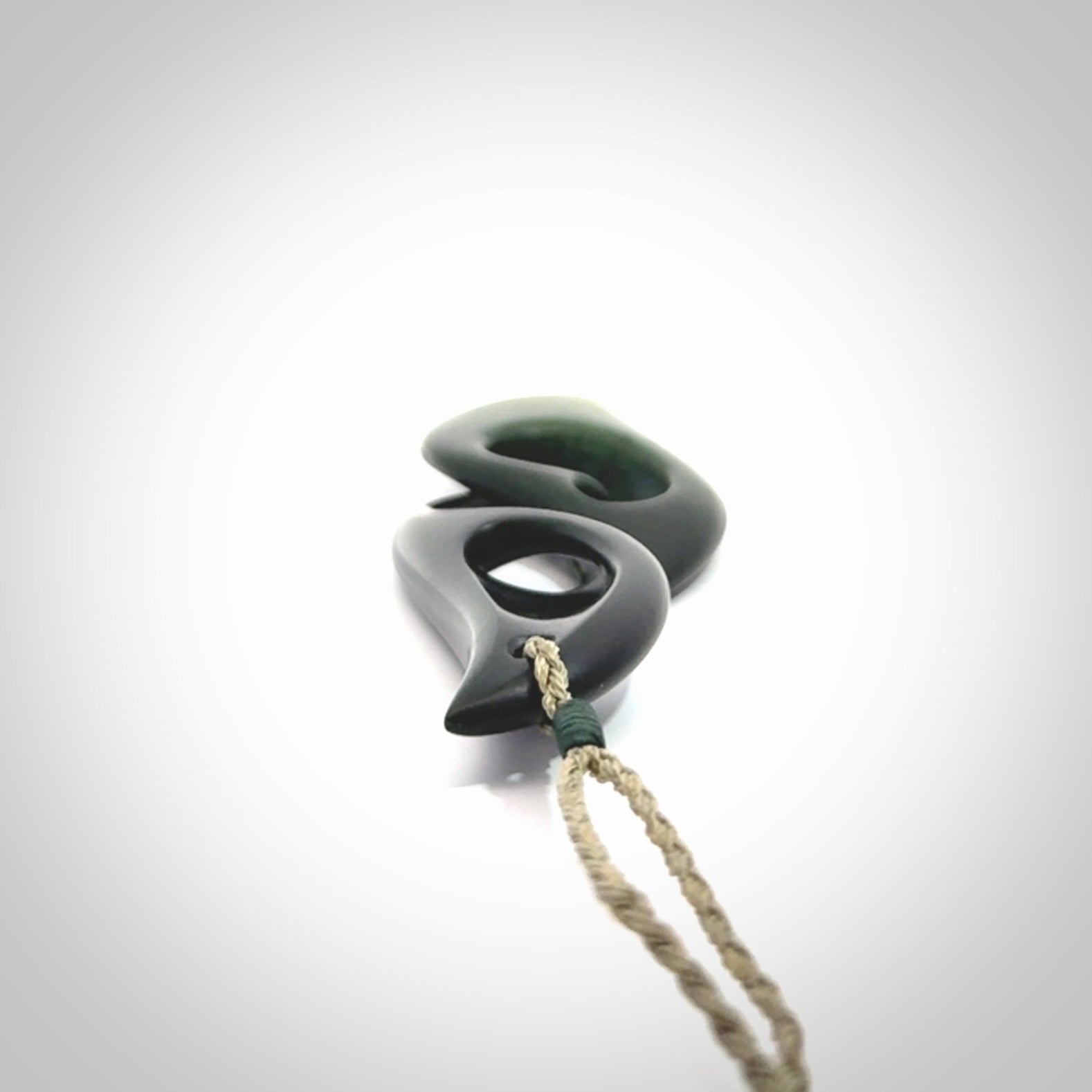 Hand carved New Zealand jade, complex twist drop pendant. Hand made complex twist pendant hand carved in New Zealand. Made by NZ Pacific, jade jewellery for sale online. One only hand made by Kerry Thompson.
