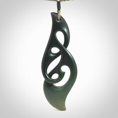 Hand carved New Zealand jade, complex twist drop pendant. Hand made complex twist pendant hand carved in New Zealand. Made by NZ Pacific, jade jewellery for sale online. One only hand made by Kerry Thompson.