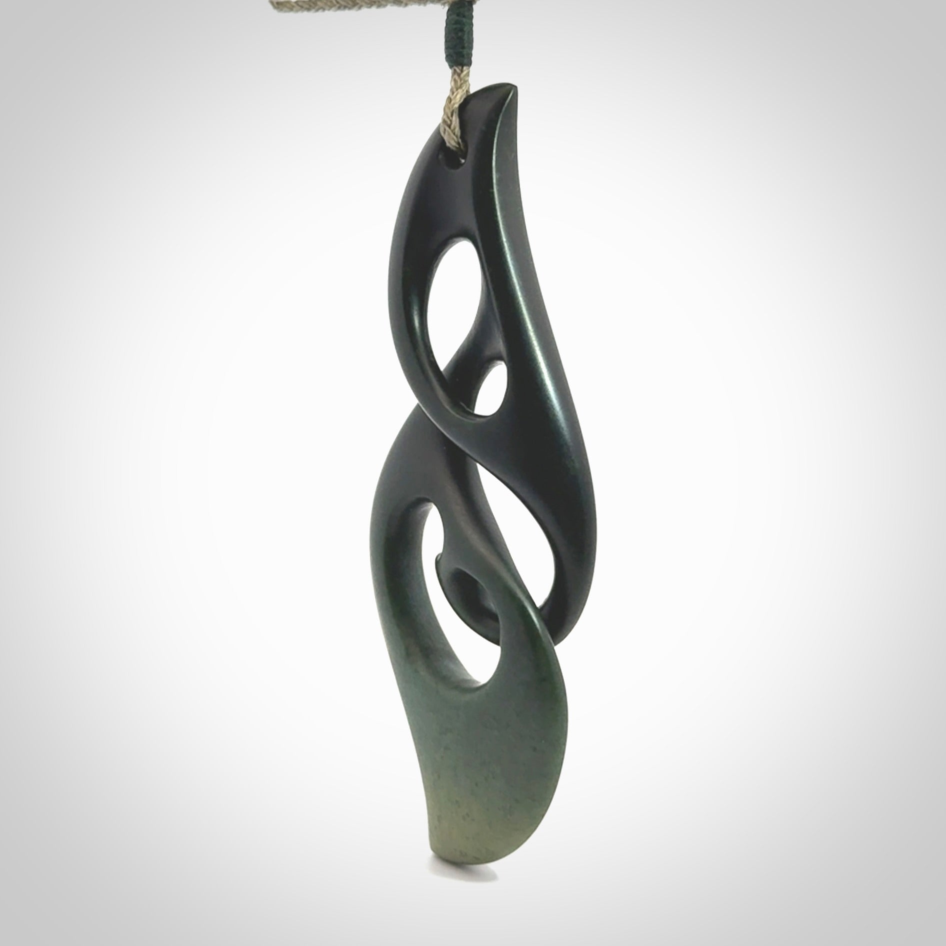 Hand carved New Zealand jade, complex twist drop pendant. Hand made complex twist pendant hand carved in New Zealand. Made by NZ Pacific, jade jewellery for sale online. One only hand made by Kerry Thompson.