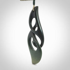 Hand carved New Zealand jade, complex twist drop pendant. Hand made complex twist pendant hand carved in New Zealand. Made by NZ Pacific, jade jewellery for sale online. One only hand made by Kerry Thompson.