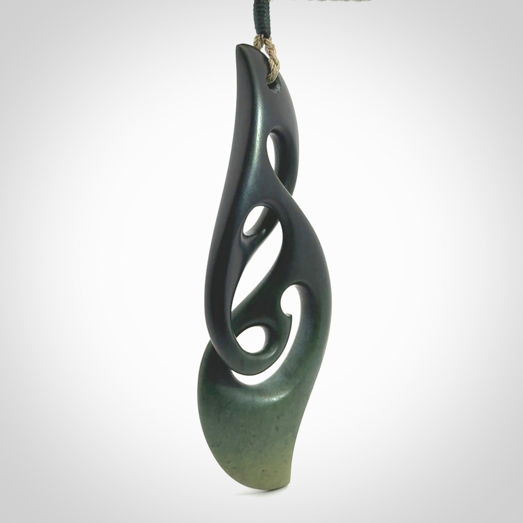 Hand carved New Zealand jade, complex twist drop pendant. Hand made complex twist pendant hand carved in New Zealand. Made by NZ Pacific, jade jewellery for sale online. One only hand made by Kerry Thompson.
