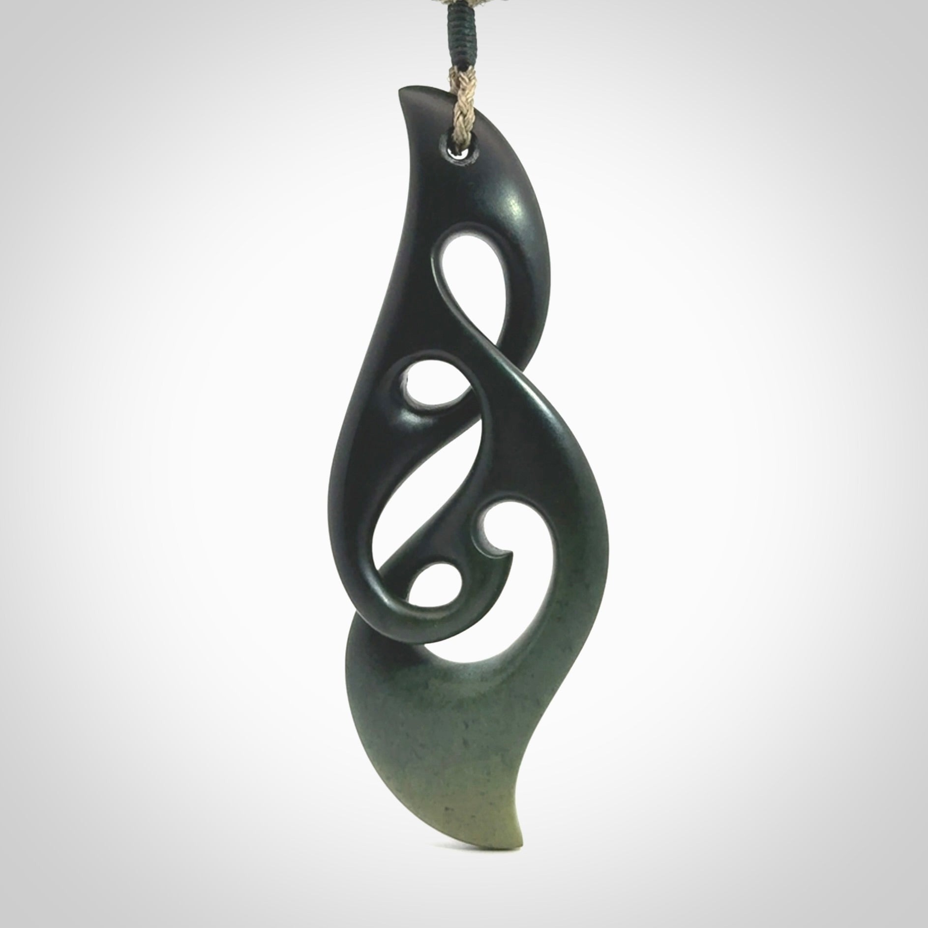 Hand carved New Zealand jade, complex twist drop pendant. Hand made complex twist pendant hand carved in New Zealand. Made by NZ Pacific, jade jewellery for sale online. One only hand made by Kerry Thompson.