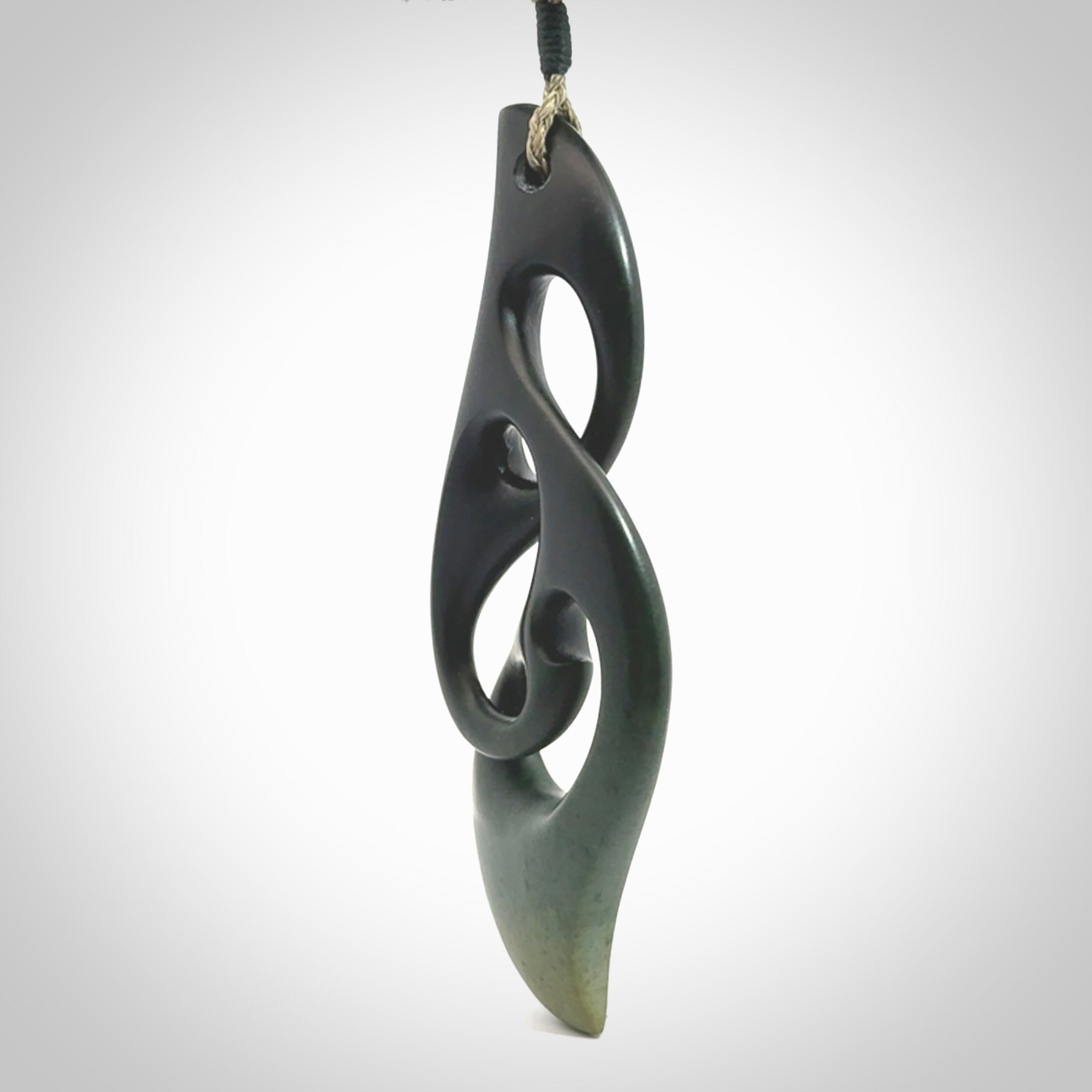 Hand carved New Zealand jade, complex twist drop pendant. Hand made complex twist pendant hand carved in New Zealand. Made by NZ Pacific, jade jewellery for sale online. One only hand made by Kerry Thompson.