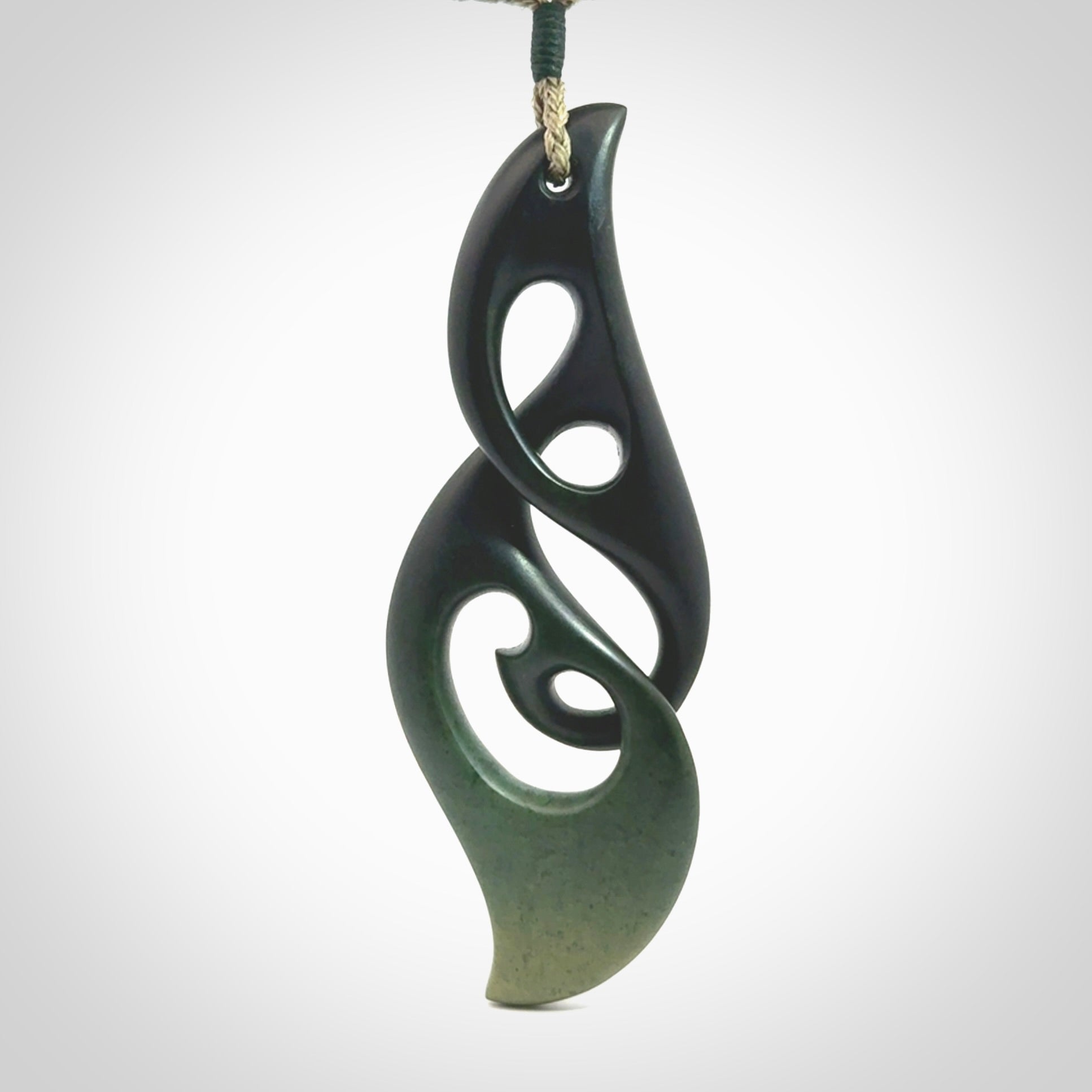 Hand carved New Zealand jade, complex twist drop pendant. Hand made complex twist pendant hand carved in New Zealand. Made by NZ Pacific, jade jewellery for sale online. One only hand made by Kerry Thompson.