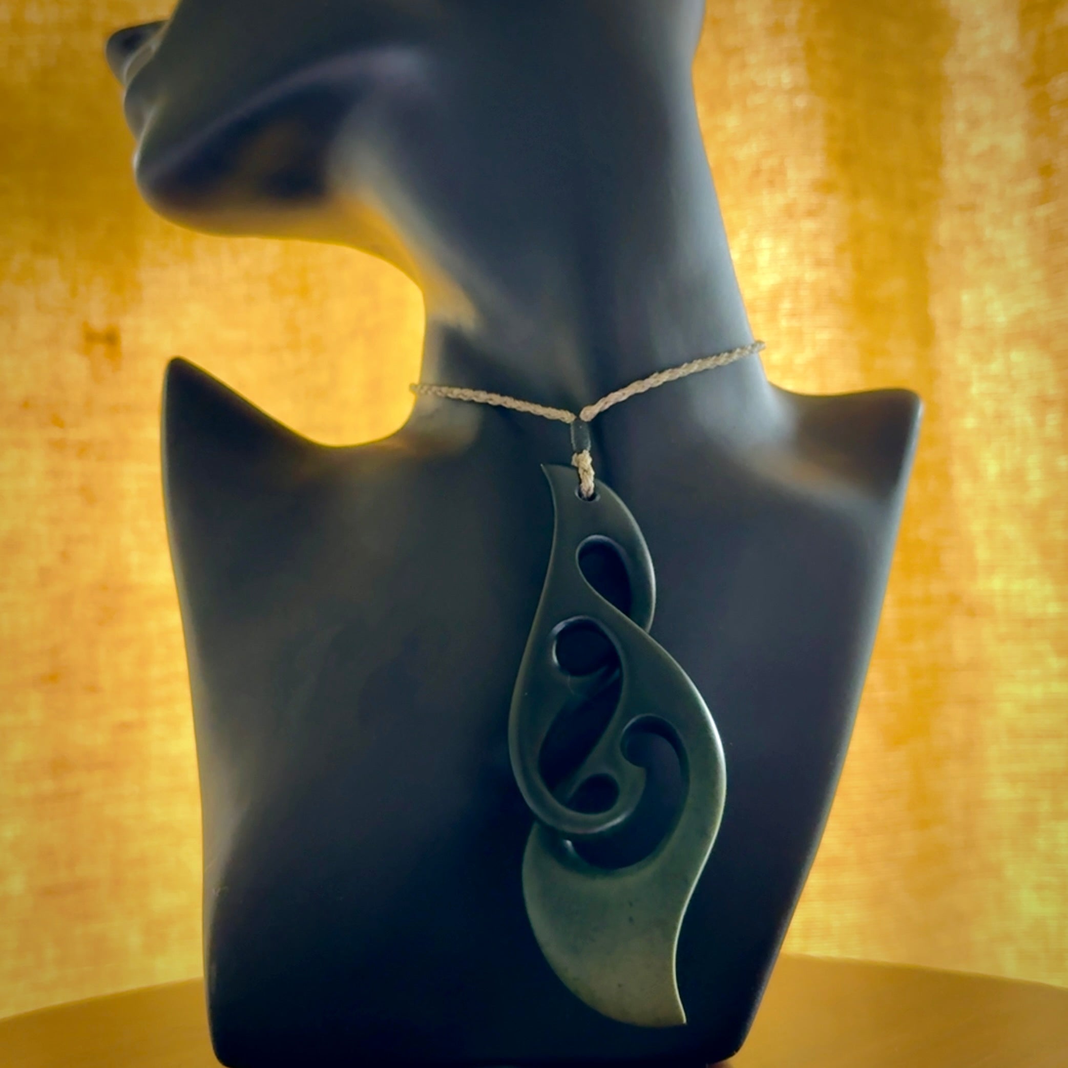Hand carved New Zealand jade, complex twist drop pendant. Hand made complex twist pendant hand carved in New Zealand. Made by NZ Pacific, jade jewellery for sale online. One only hand made by Kerry Thompson.