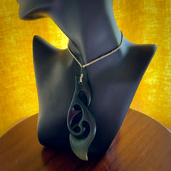 Hand carved New Zealand jade, complex twist drop pendant. Hand made complex twist pendant hand carved in New Zealand. Made by NZ Pacific, jade jewellery for sale online. One only hand made by Kerry Thompson.