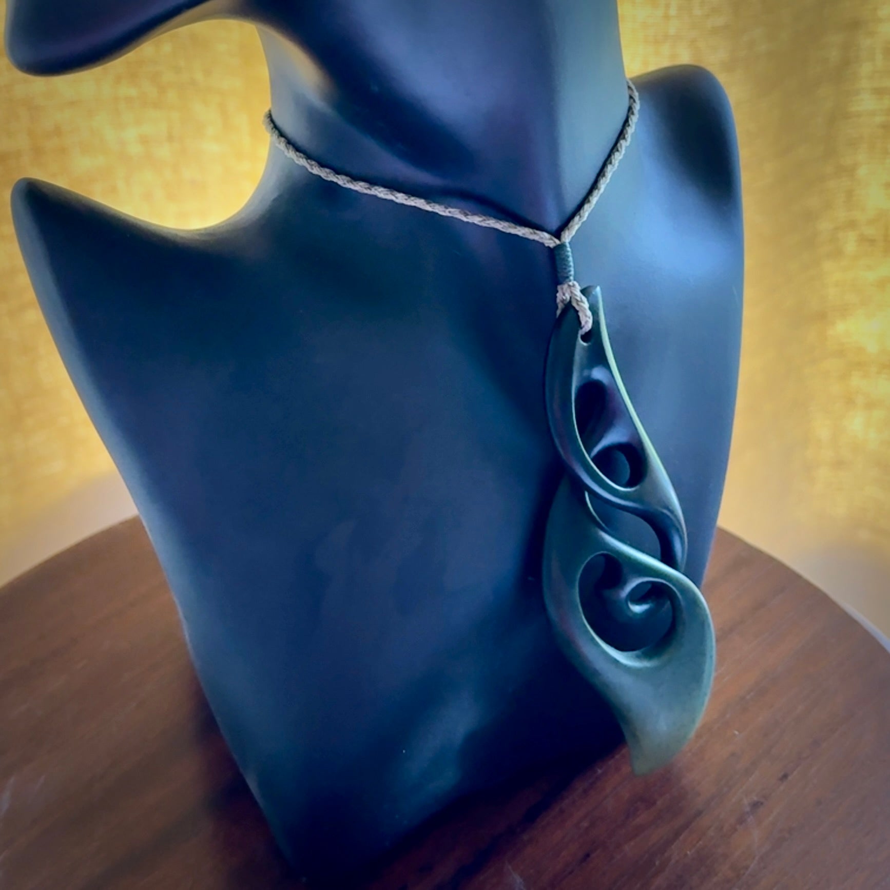 Hand carved New Zealand jade, complex twist drop pendant. Hand made complex twist pendant hand carved in New Zealand. Made by NZ Pacific, jade jewellery for sale online. One only hand made by Kerry Thompson.