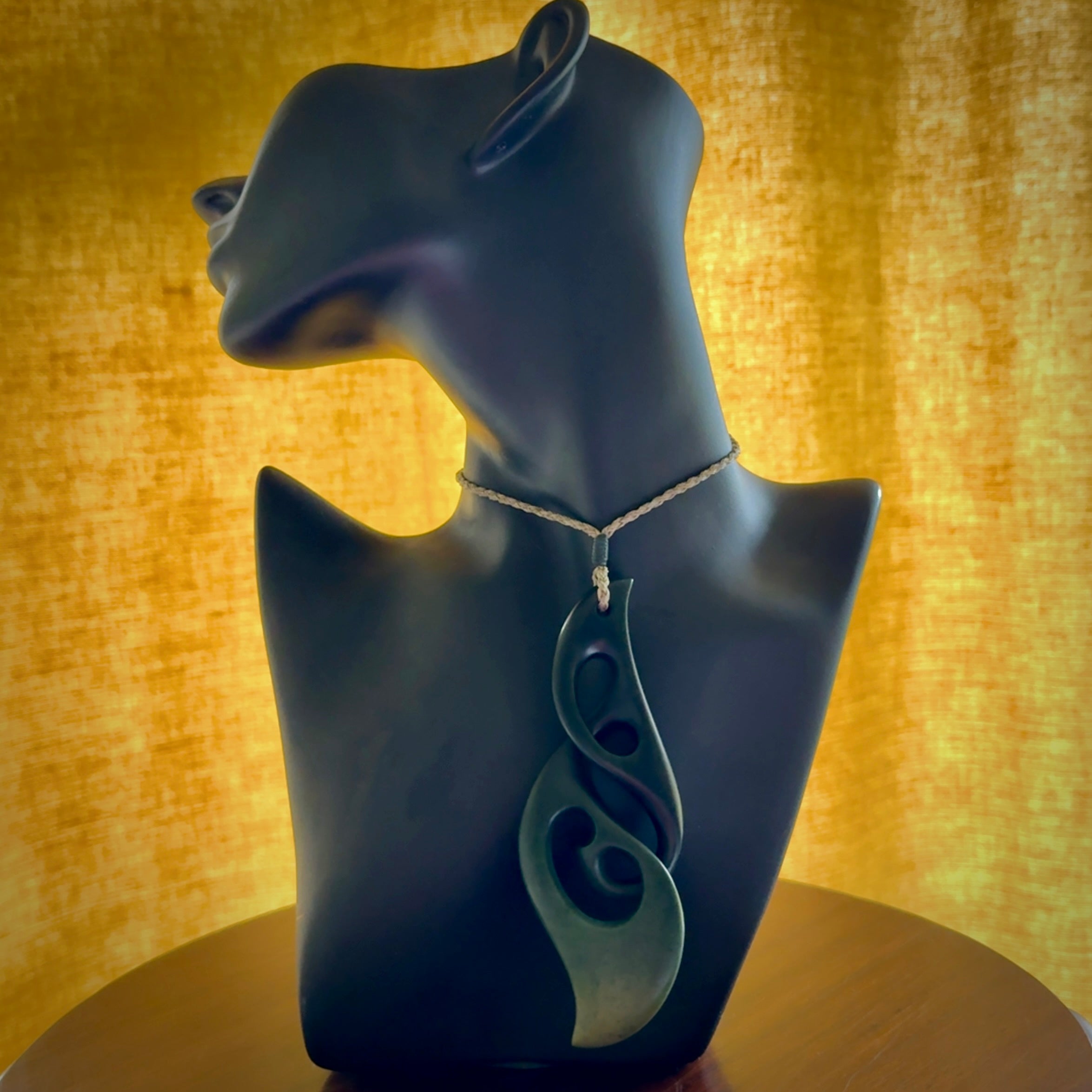 Hand carved New Zealand jade, complex twist drop pendant. Hand made complex twist pendant hand carved in New Zealand. Made by NZ Pacific, jade jewellery for sale online. One only hand made by Kerry Thompson.