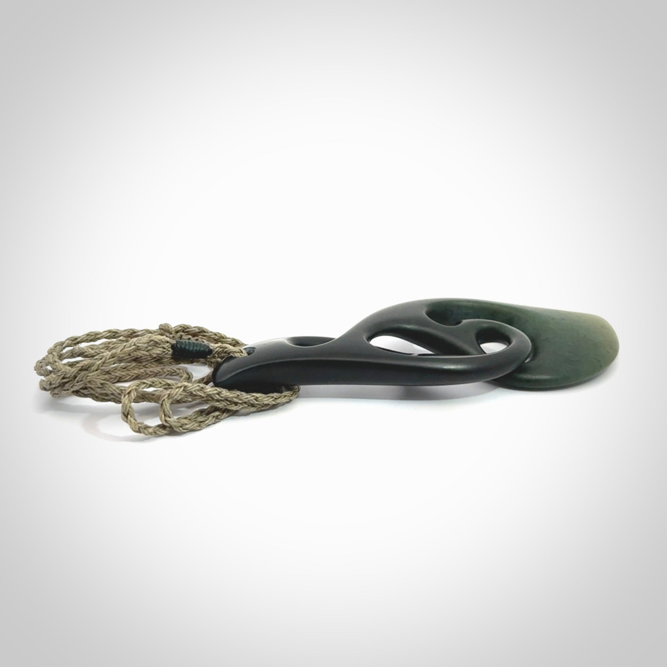 Hand carved New Zealand jade, complex twist drop pendant. Hand made complex twist pendant hand carved in New Zealand. Made by NZ Pacific, jade jewellery for sale online. One only hand made by Kerry Thompson.