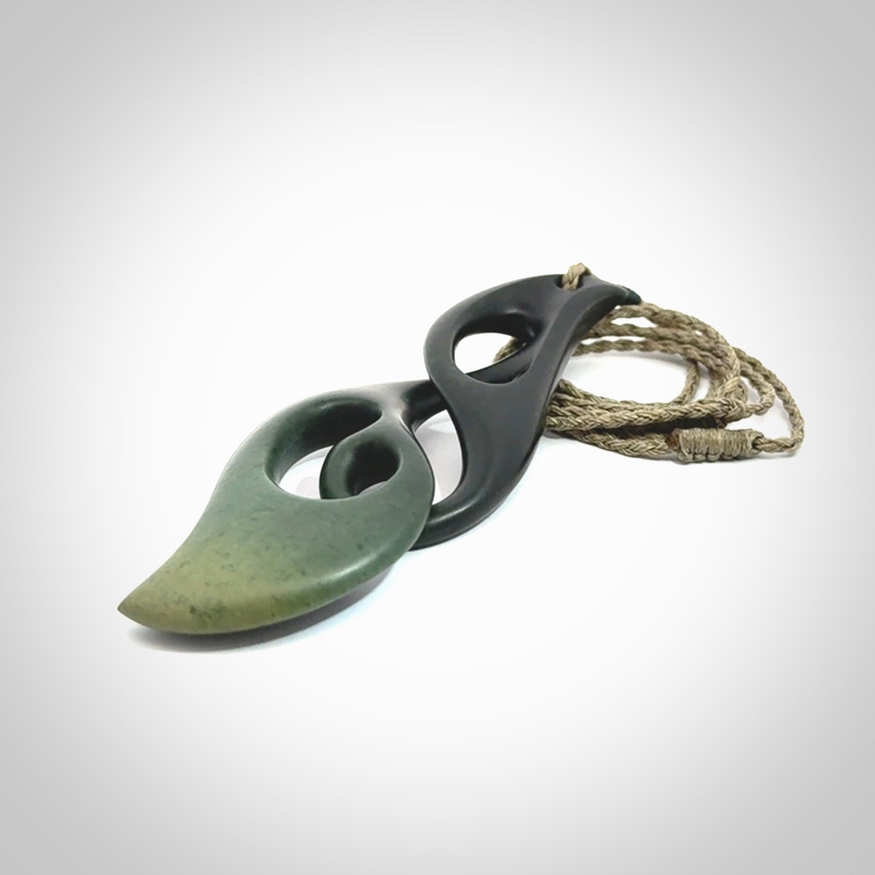 Hand carved New Zealand jade, complex twist drop pendant. Hand made complex twist pendant hand carved in New Zealand. Made by NZ Pacific, jade jewellery for sale online. One only hand made by Kerry Thompson.
