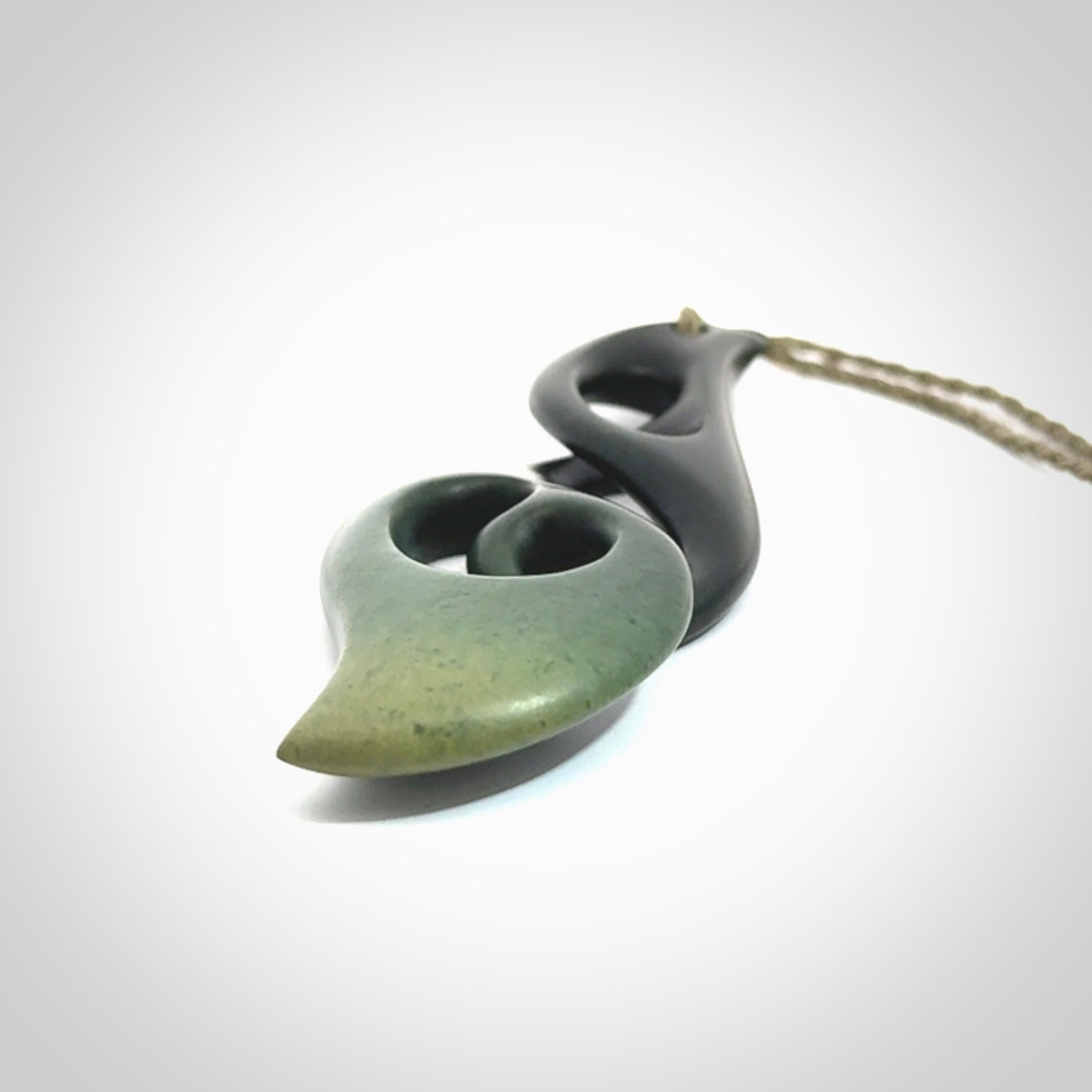 Hand carved New Zealand jade, complex twist drop pendant. Hand made complex twist pendant hand carved in New Zealand. Made by NZ Pacific, jade jewellery for sale online. One only hand made by Kerry Thompson.