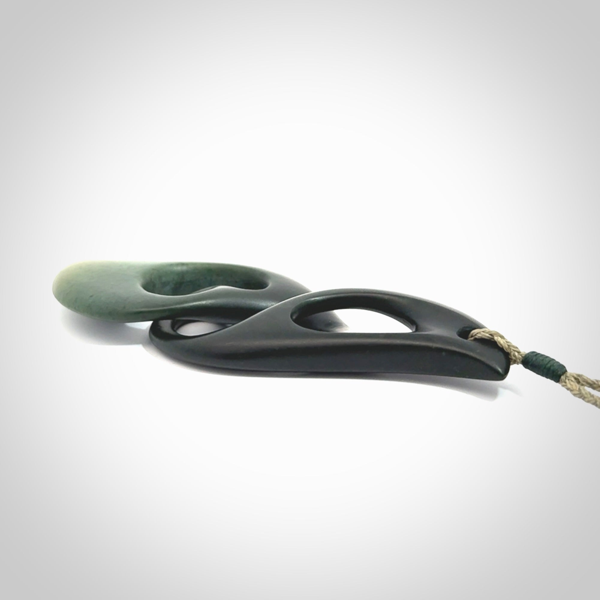 Hand carved New Zealand jade, complex twist drop pendant. Hand made complex twist pendant hand carved in New Zealand. Made by NZ Pacific, jade jewellery for sale online. One only hand made by Kerry Thompson.