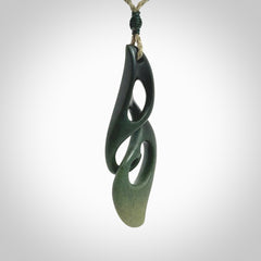 A hand carved twist pendant from New Zealand Jade. The cord is a khaki green colour and is adjustable.