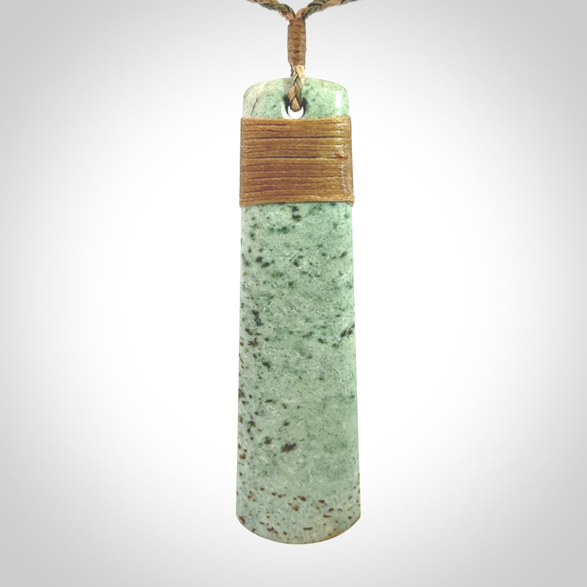 A hand carved large New Zealand Jade drop, roimata, necklace. The cord is a khaki/tan colour and is adjustable. A large sized hand made drop necklace by New Zealand artist Kerry Thompson. One off work of art to wear.