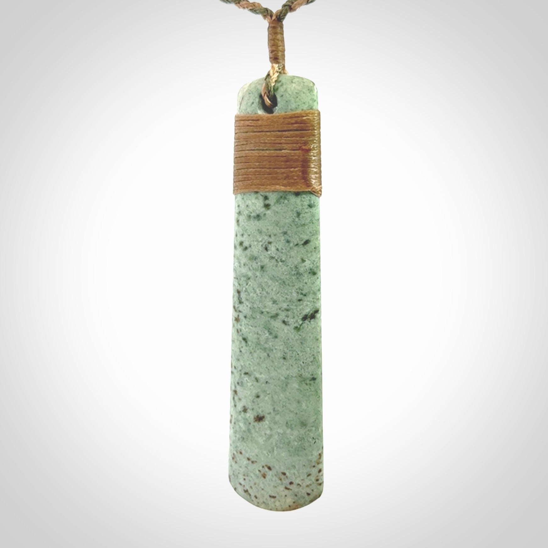 A hand carved large New Zealand Jade drop, roimata, necklace. The cord is a khaki/tan colour and is adjustable. A large sized hand made drop necklace by New Zealand artist Kerry Thompson. One off work of art to wear.