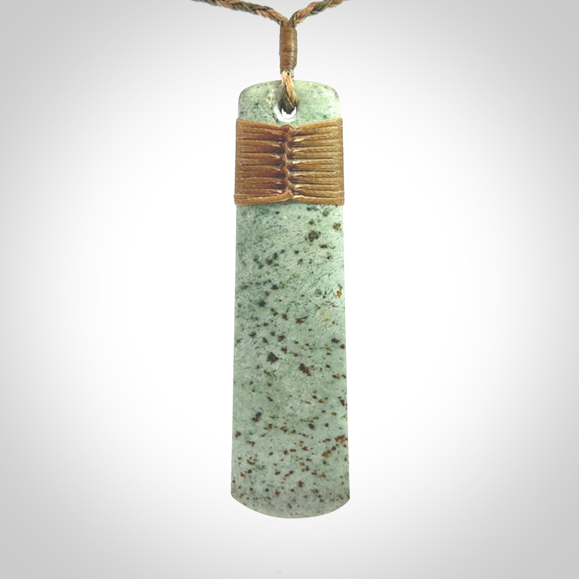 A hand carved large New Zealand Jade drop, roimata, necklace. The cord is a khaki/tan colour and is adjustable. A large sized hand made drop necklace by New Zealand artist Kerry Thompson. One off work of art to wear.