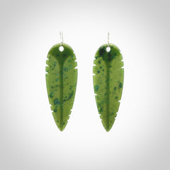 This picture shows British Columbian jade kaka feather earrings with sterling silver hooks. Hand made unique and contemporary feather earrings by Kerry Thompson. Hand carved here in New Zealand from British Columbian Jade. One pair only.