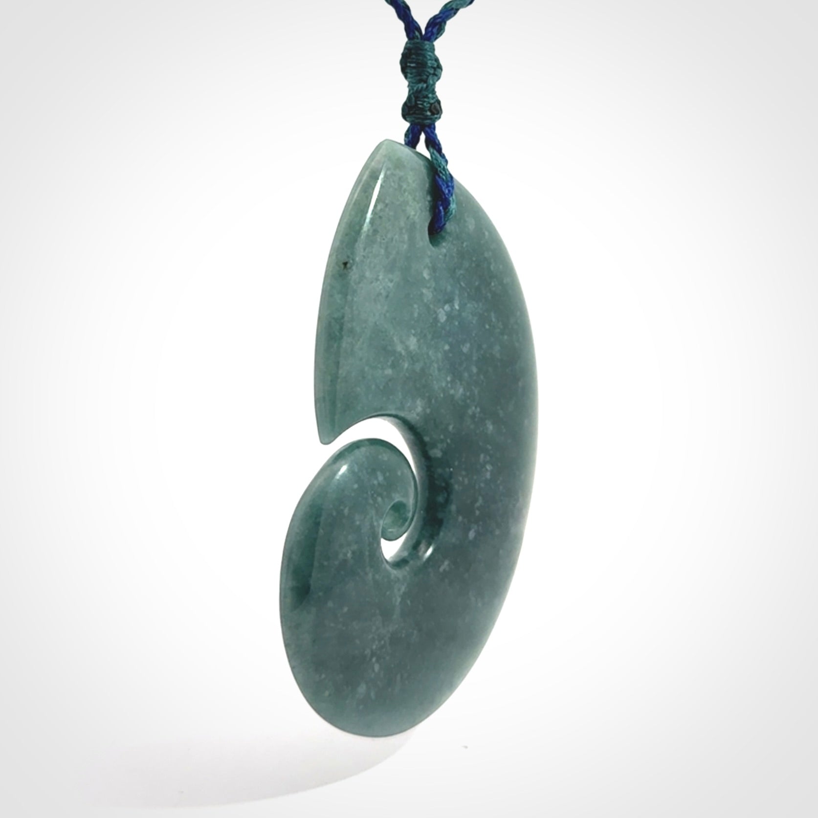 Hand carved Guatemalan Jade koru pendant.