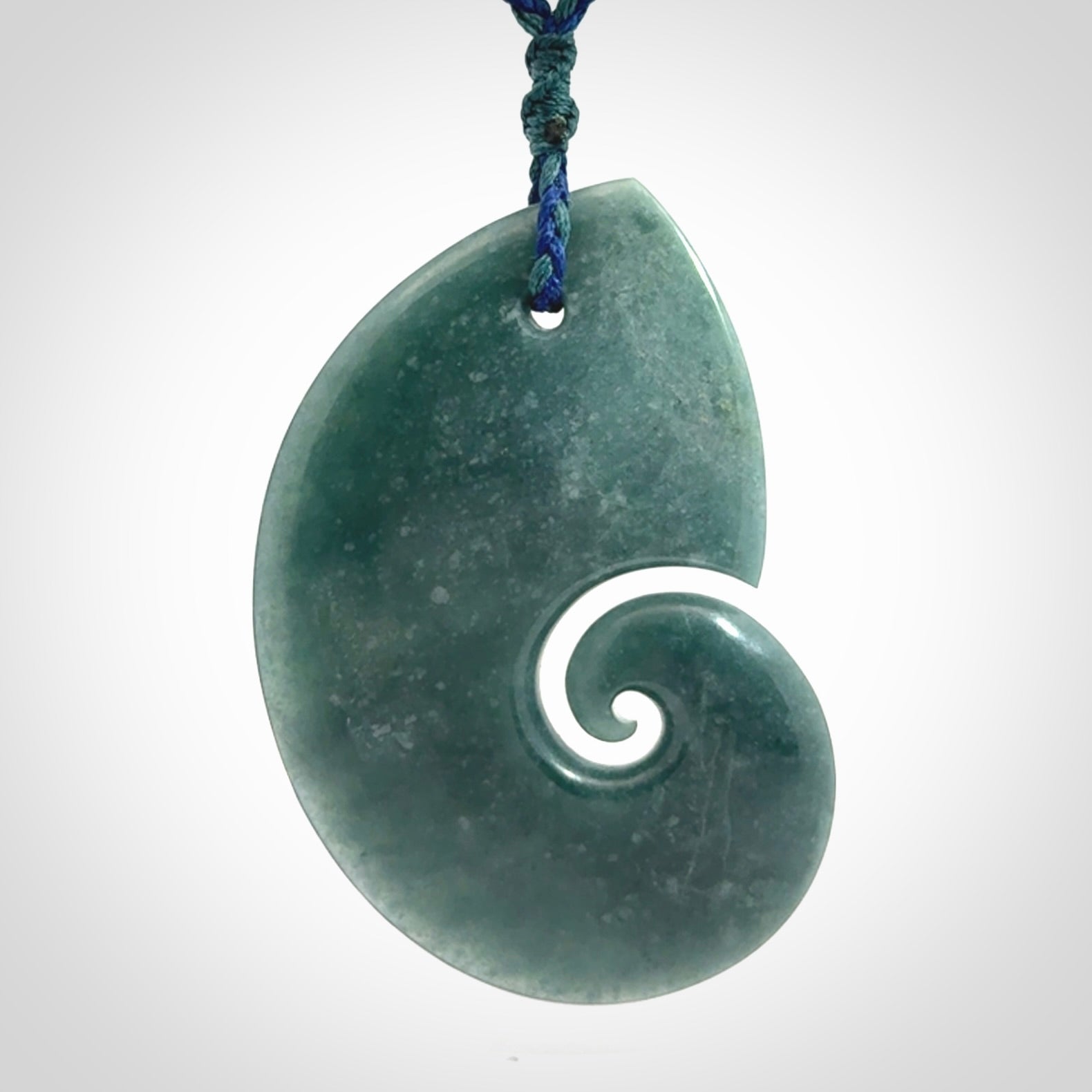 Hand carved Guatemalan Jade koru pendant.