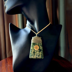 Carved from a lovely piece of local New Zealand Jade. The quality of the workmanship and design is outstanding - this is a piece you will want to wear all the time. We have suspended this from a oat cord which can be adjusted with a couple of slip knots and a fern green binding.