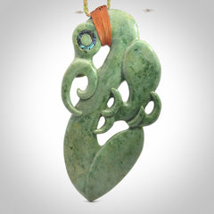 This picture shows a large traditional manaia pendant carved in New Zealand Jade.