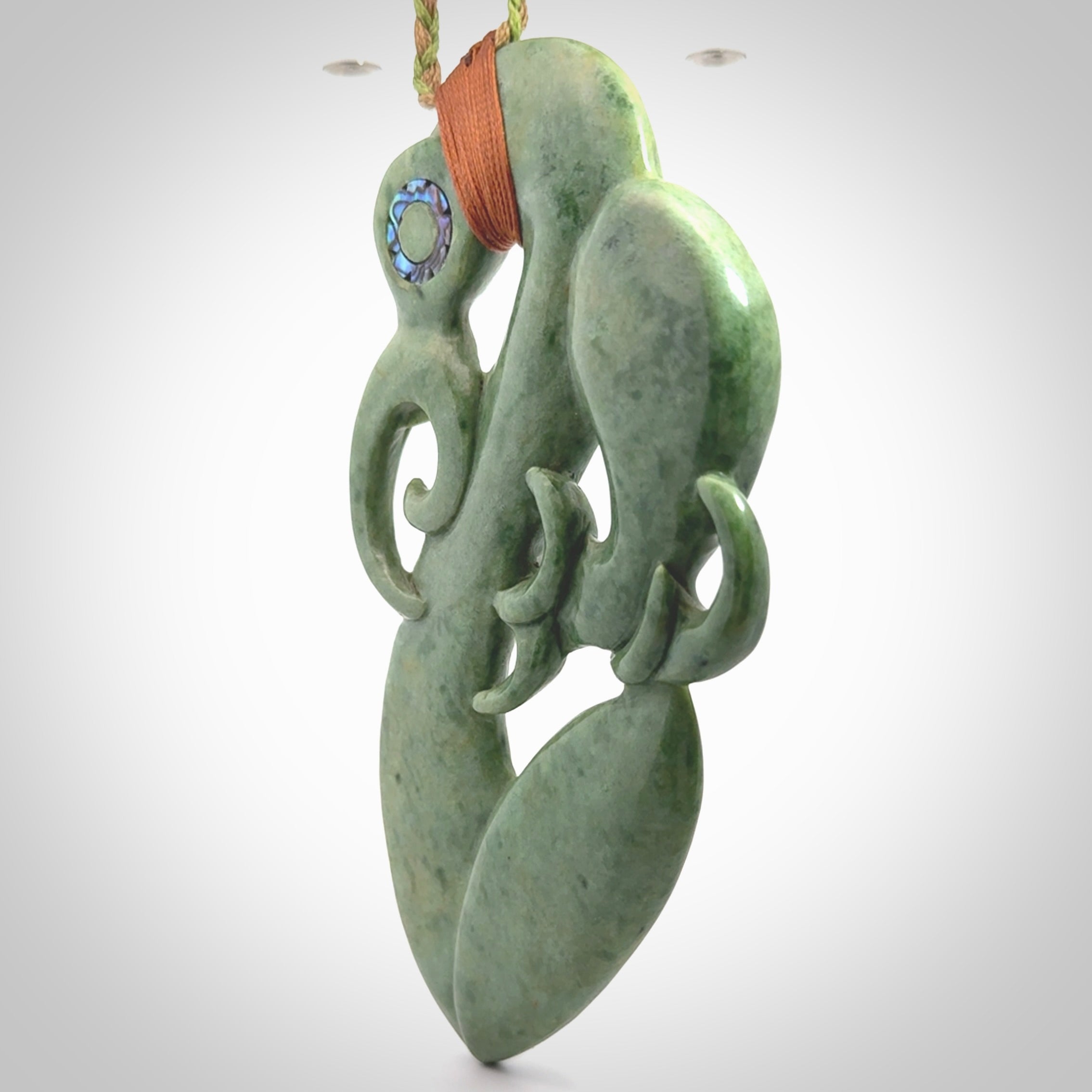 This picture shows a large traditional manaia pendant carved in New Zealand Jade.