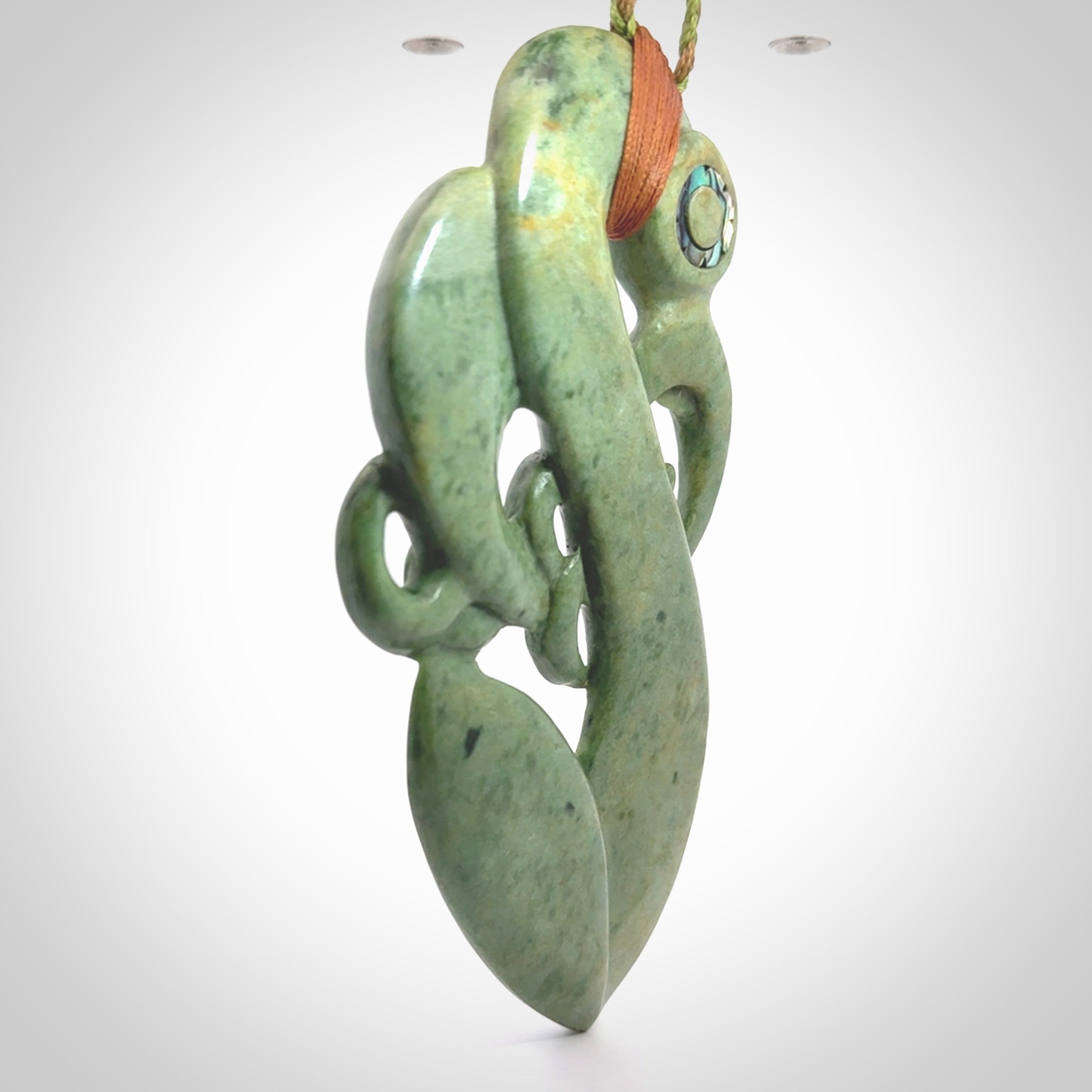 This picture shows a large traditional manaia pendant carved in New Zealand Jade.