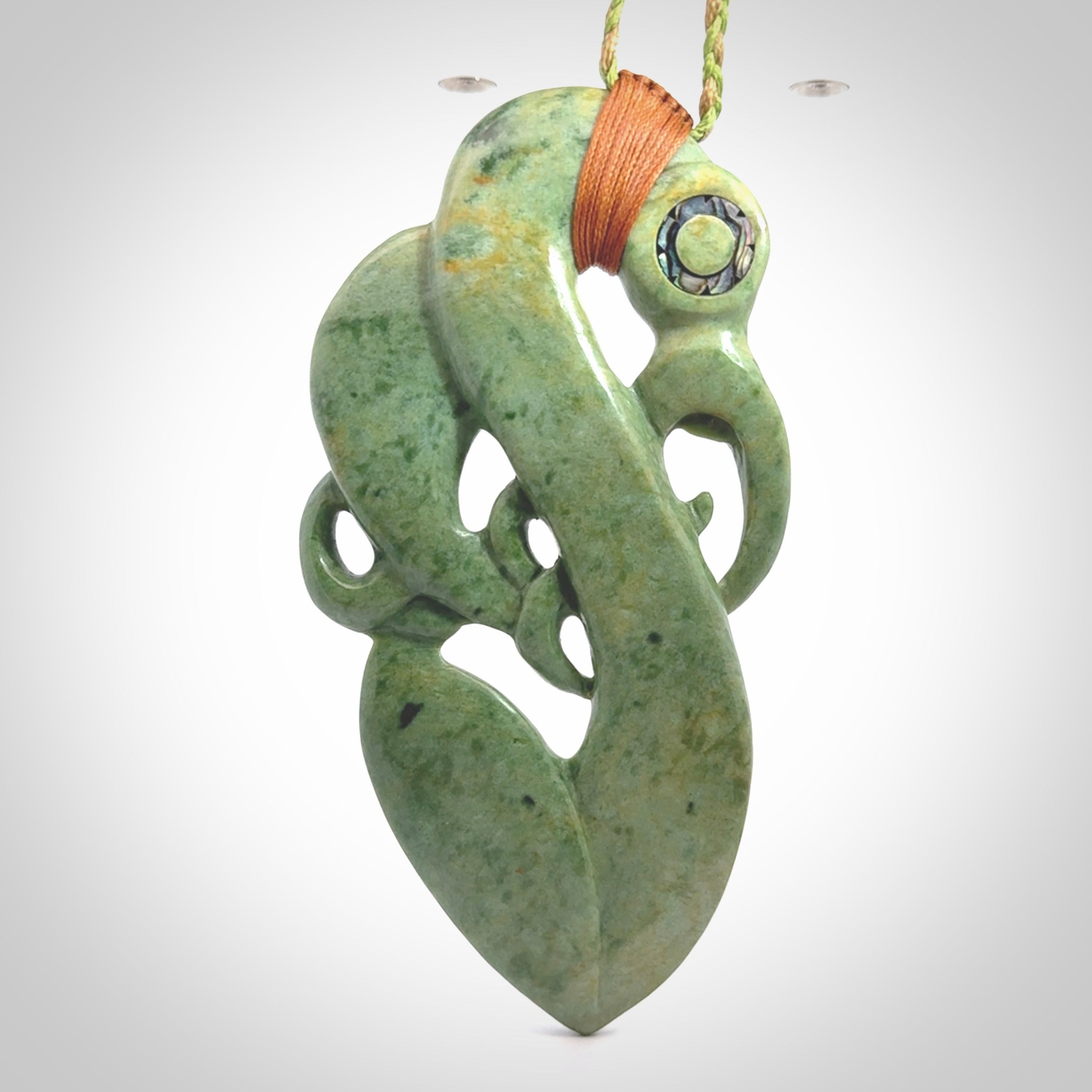 This picture shows a large traditional manaia pendant carved in New Zealand Jade.