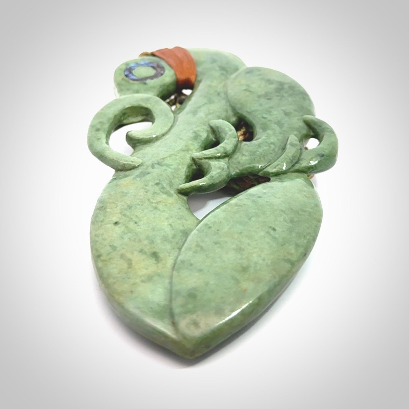 This picture shows a large traditional manaia pendant carved in New Zealand Jade.