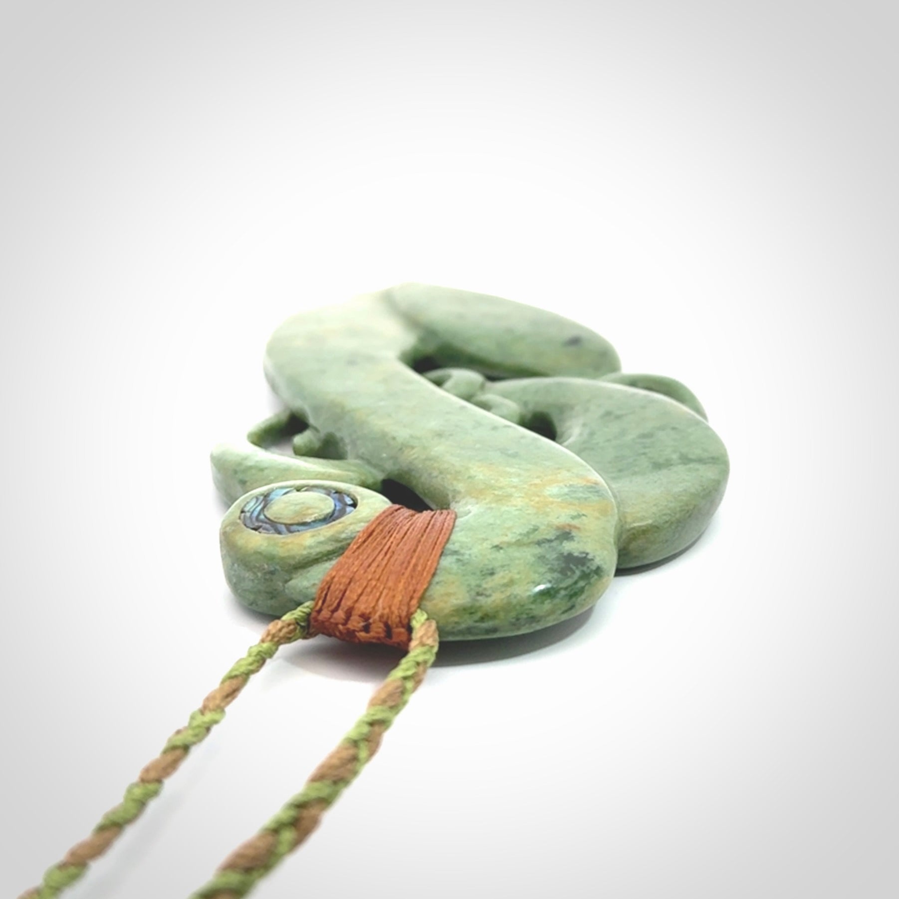 This picture shows a large traditional manaia pendant carved in New Zealand Jade.