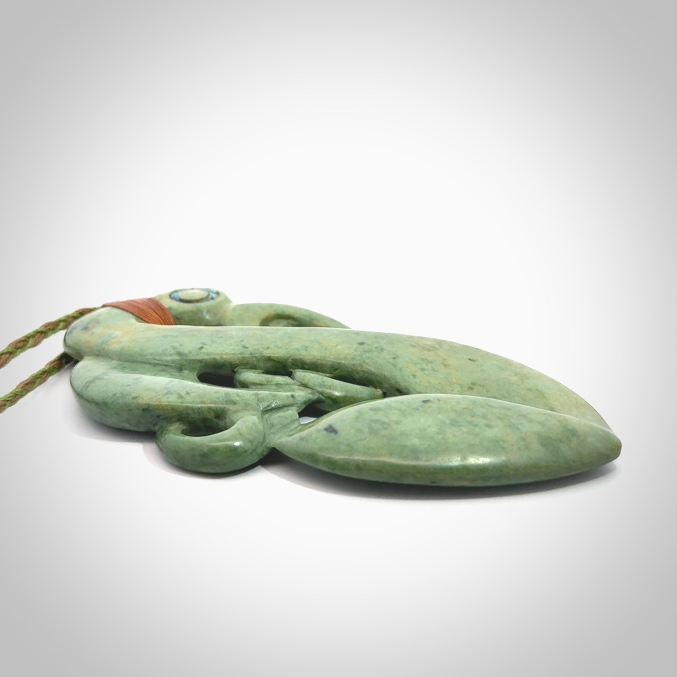 This picture shows a large traditional manaia pendant carved in New Zealand Jade.