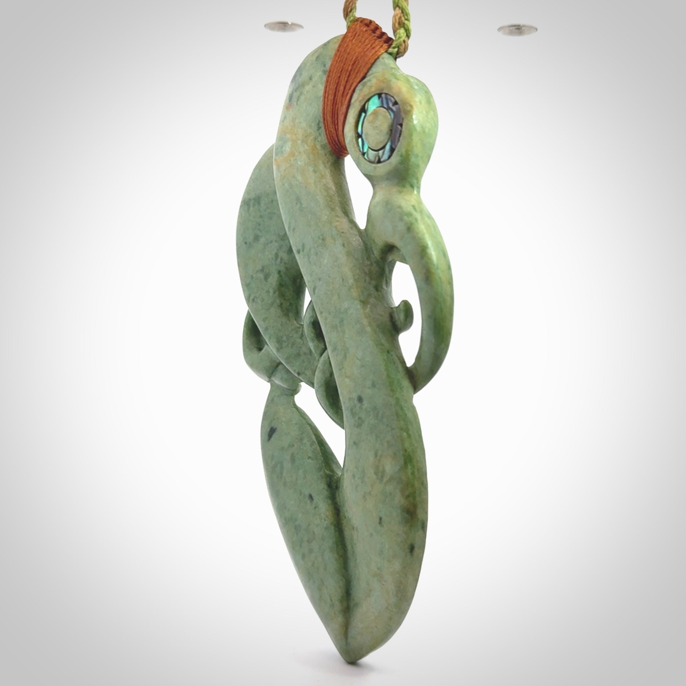This picture shows a large traditional manaia pendant carved in New Zealand Jade.