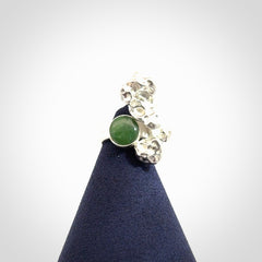 This is a handcrafted New Zealand Pounamu, Jade and sterling silver ring.