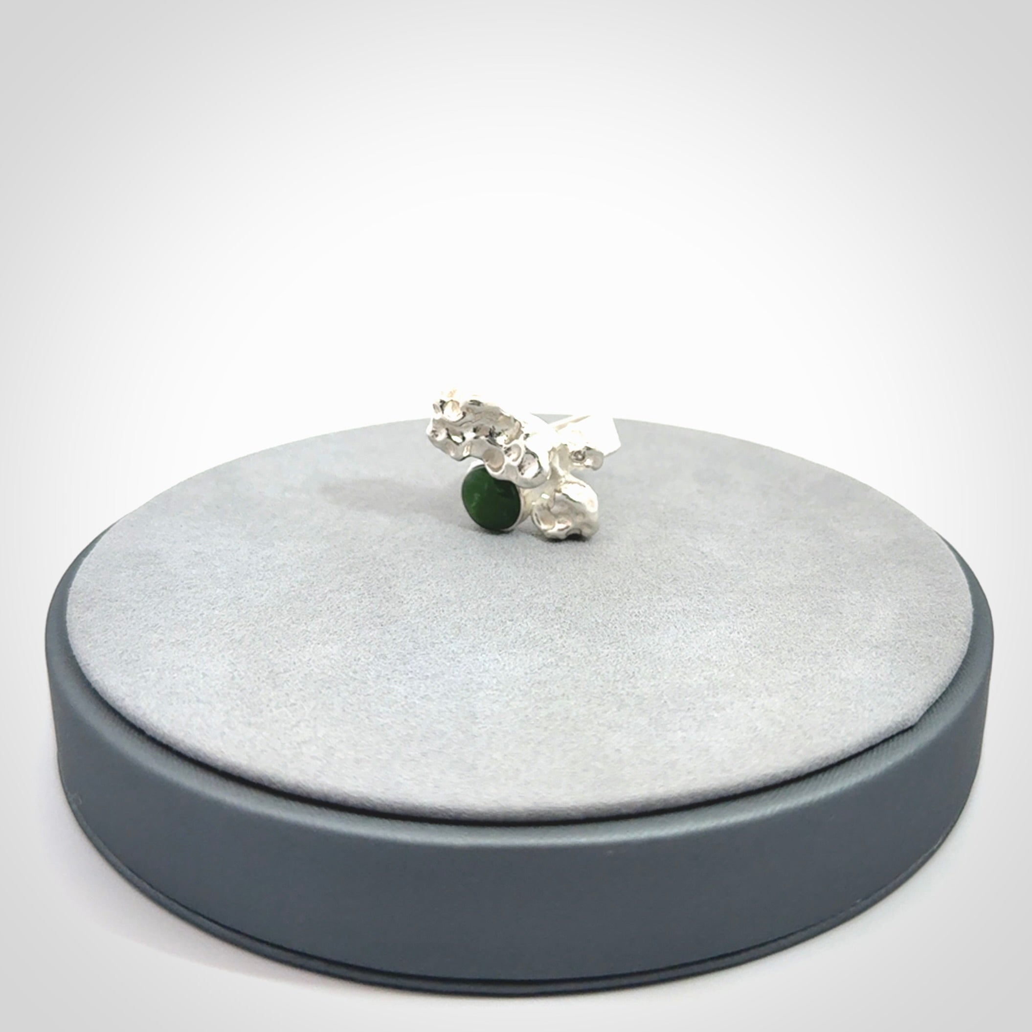 This is a handcrafted New Zealand Pounamu, Jade and sterling silver ring.