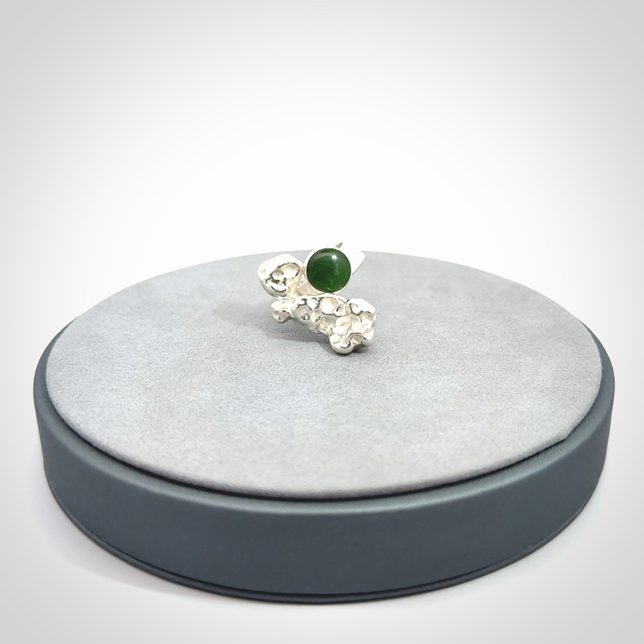 This is a handcrafted New Zealand Pounamu, Jade and sterling silver ring.