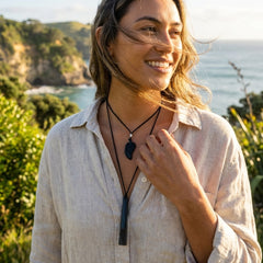 A woman wearing black jade pendants