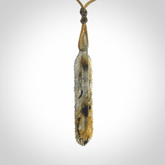 This is a hand carved feather pendant made from Labradorite stone.