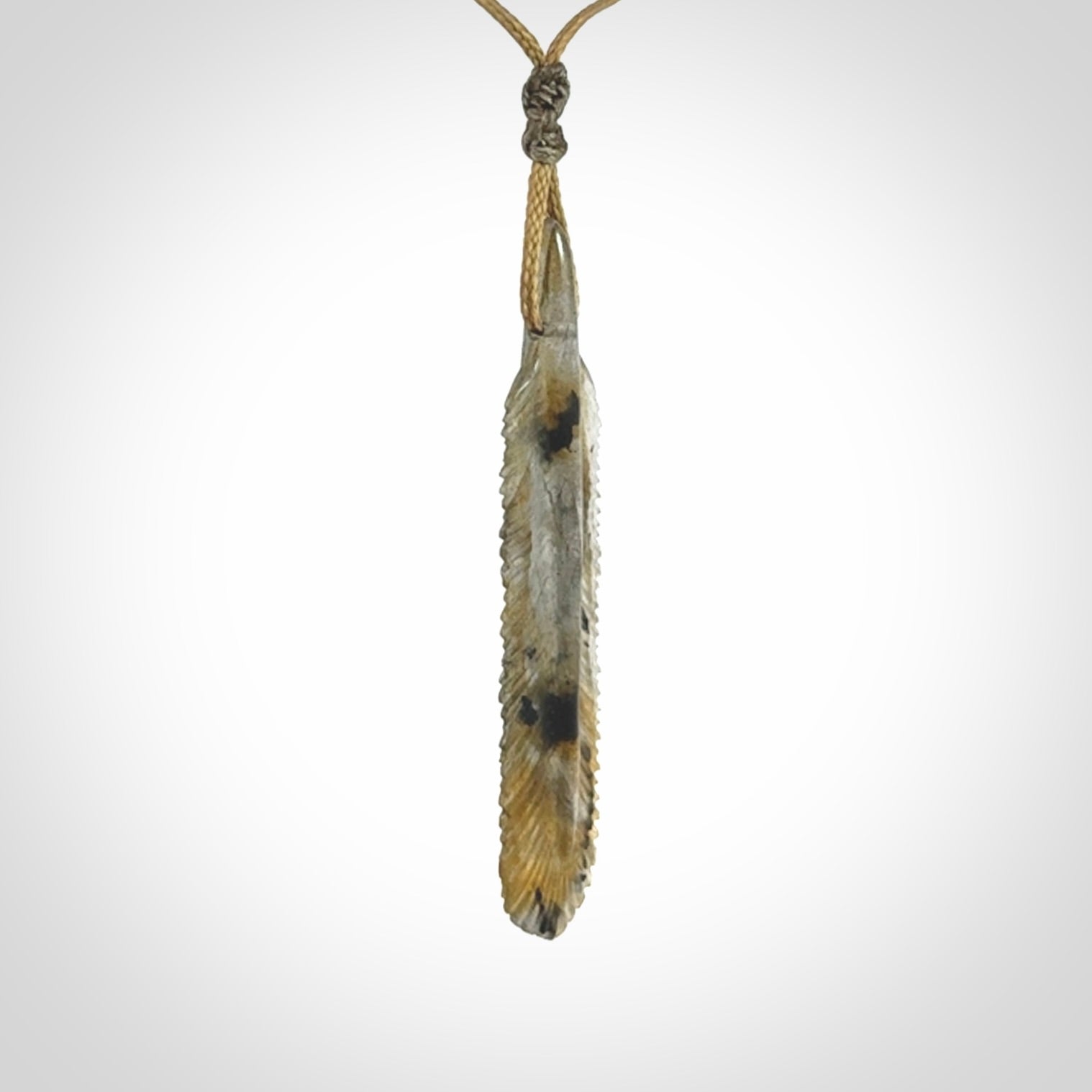 This is a hand carved feather pendant made from Labradorite stone.