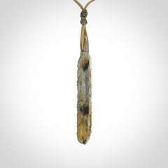 This is a hand carved feather pendant made from Labradorite stone.