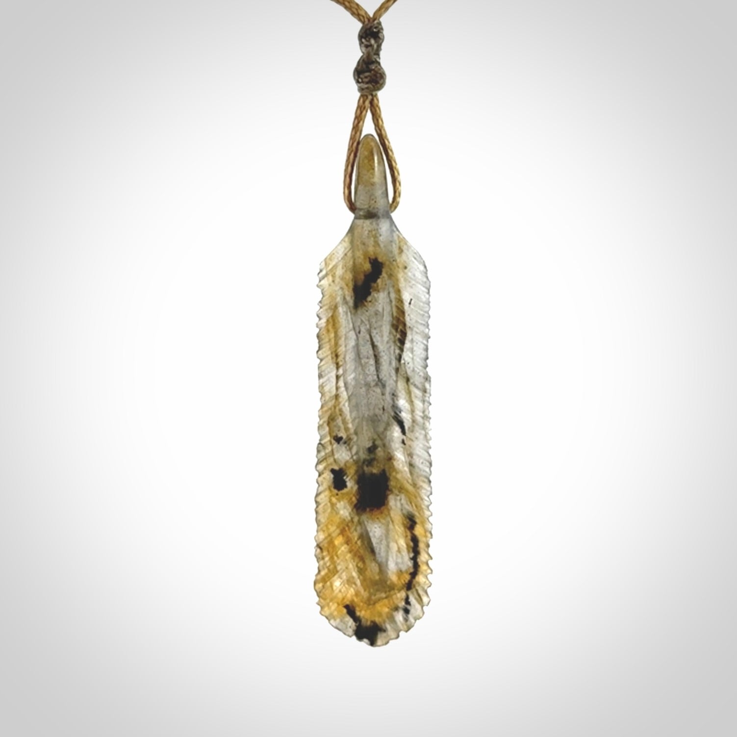 This is a hand carved feather pendant made from Labradorite stone.