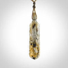 This is a hand carved feather pendant made from Labradorite stone.