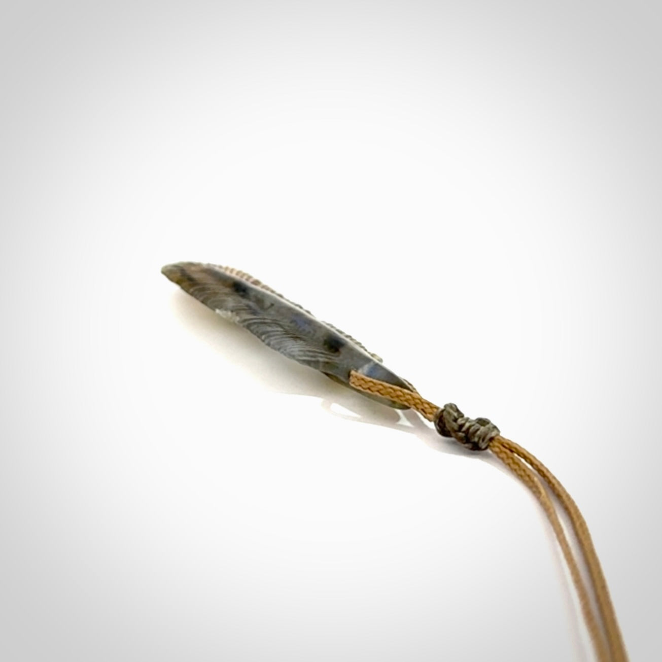 This is a hand carved feather pendant made from Labradorite stone.