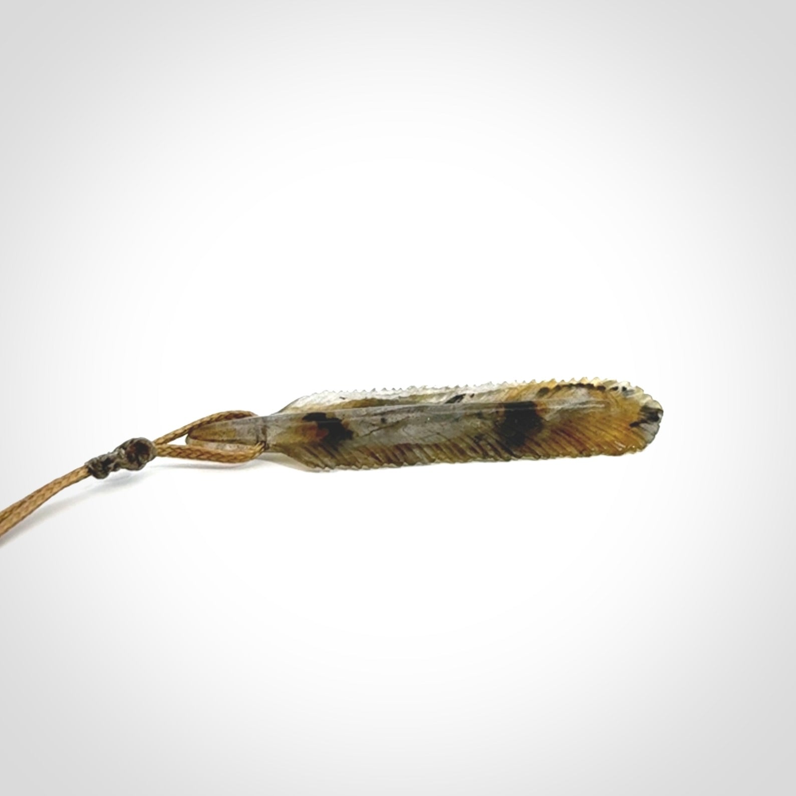 This is a hand carved feather pendant made from Labradorite stone.