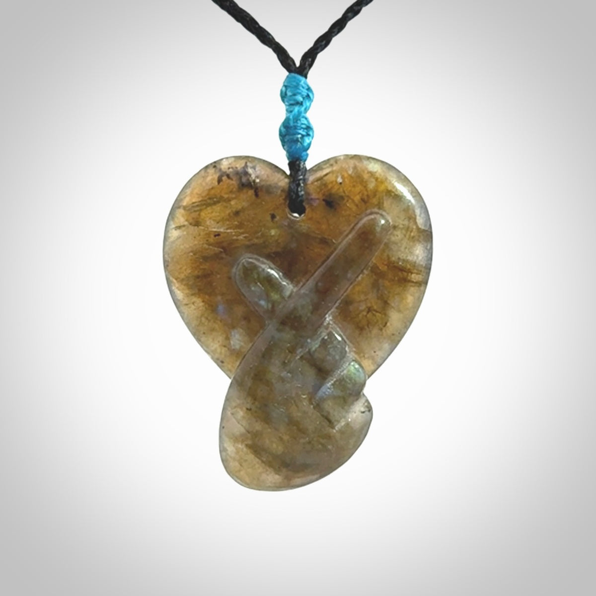 This is a hand carved love heart pendant made from Labradorite stone.