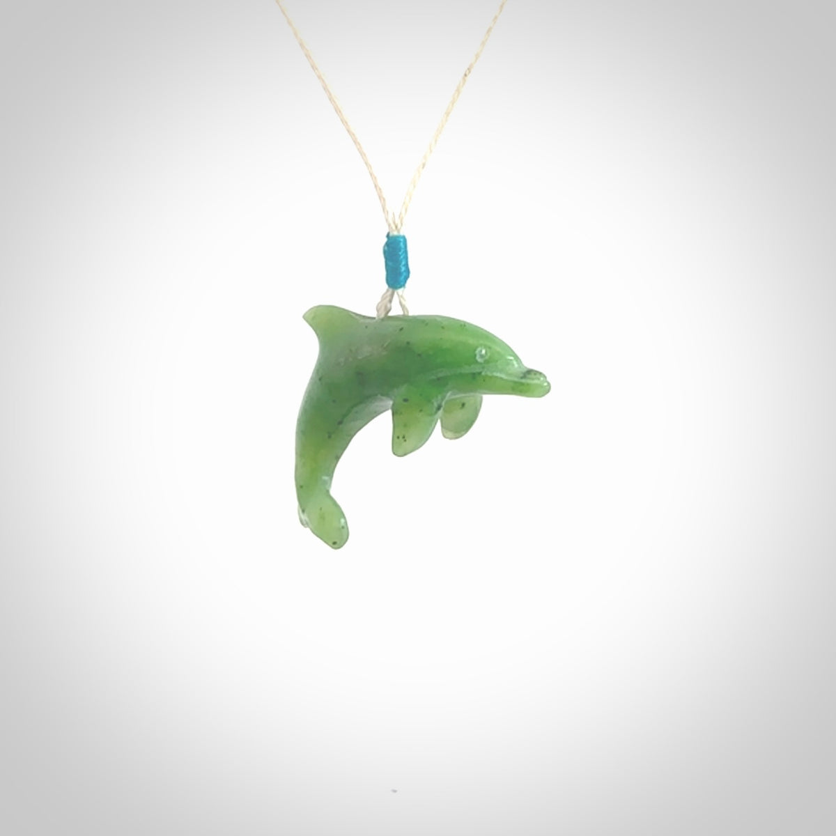 This is a gorgeous little dolphin pendant carved in green nephrite jade. The cord is fine and length adjustable so you can position the little jade dolphin where it suits you best. Shipping is free worldwide.