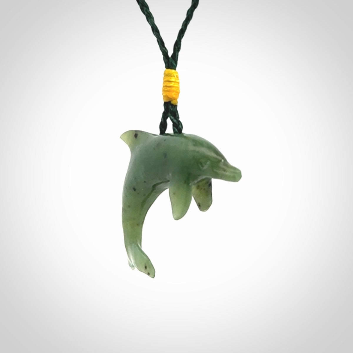 This is a gorgeous little dolphin pendant carved in green nephrite jade. The cord is fine and length adjustable so you can position the little jade dolphin where it suits you best. Shipping is free worldwide.