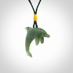 This is a gorgeous little dolphin pendant carved in green nephrite jade. The cord is fine and length adjustable so you can position the little jade dolphin where it suits you best. Shipping is free worldwide.