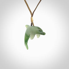 This is a gorgeous little dolphin pendant carved in green nephrite jade. The cord is fine and length adjustable so you can position the little jade dolphin where it suits you best. Shipping is free worldwide.