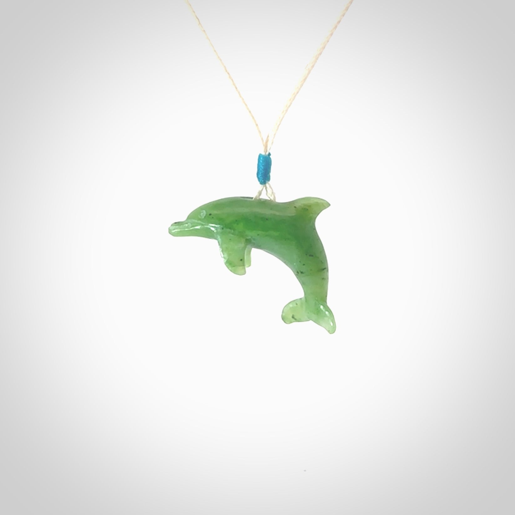 This is a gorgeous little dolphin pendant carved in green nephrite jade. The cord is fine and length adjustable so you can position the little jade dolphin where it suits you best. Shipping is free worldwide.
